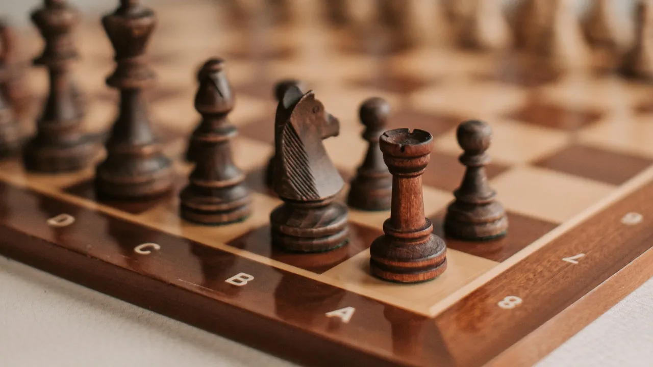 Close-up of wooden chess pieces mid-game on a classic board